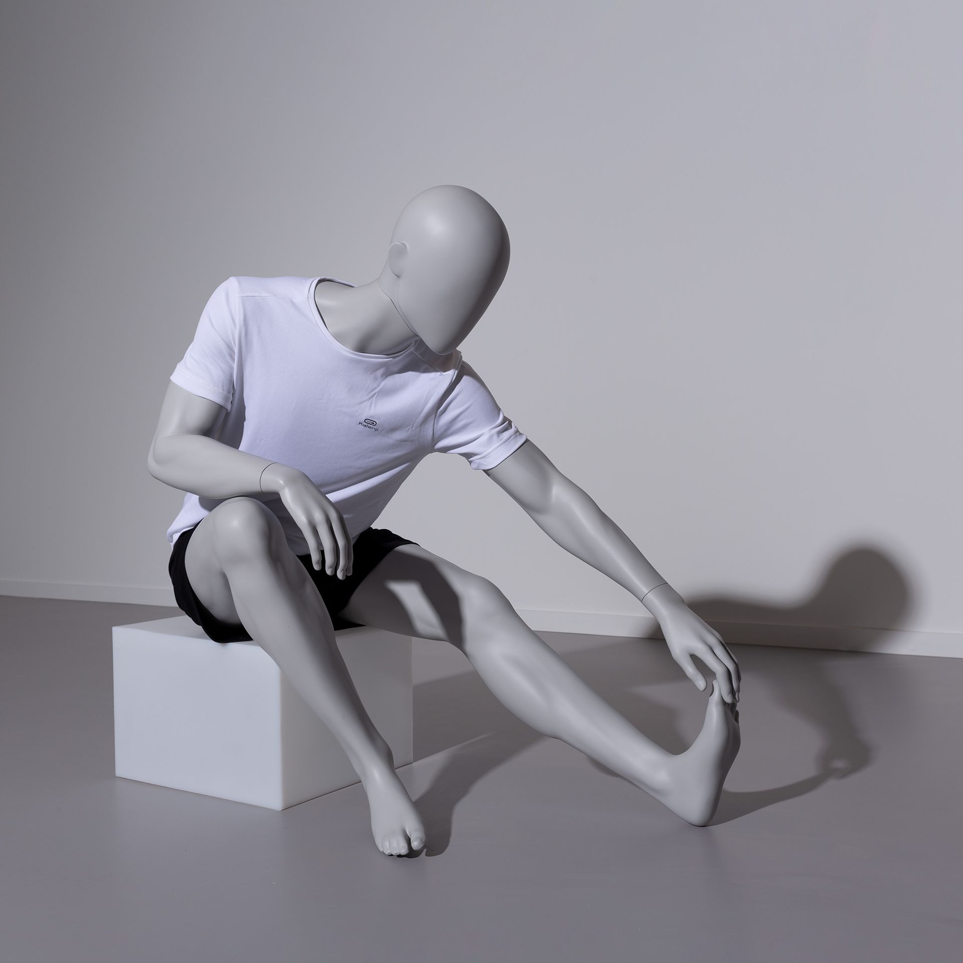 Stretching sport mannequin, male, grey, abstract head, seated pose 321